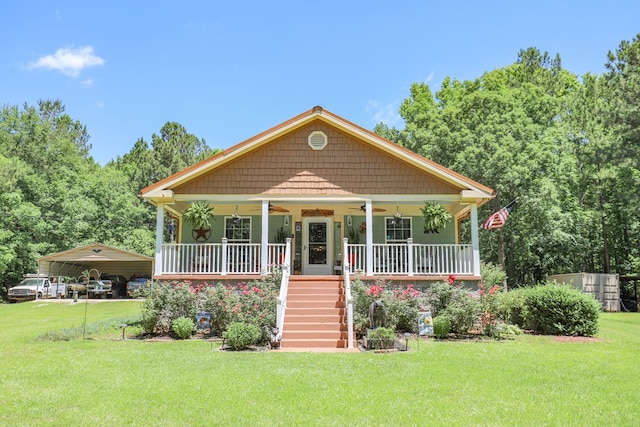 287 Napier Rd, Eatonton, GA 31024 - bungalow-style house featuring ceiling fan, stairway, a detached carport, and a front yard