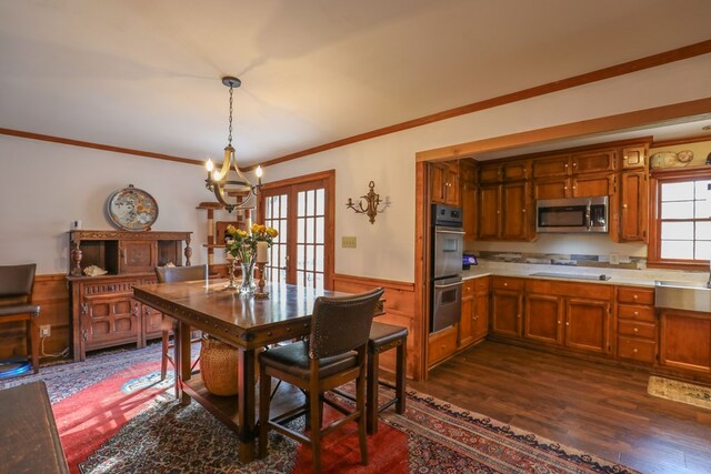 3715 Sinclair Dam Rd, Milledgeville, GA 31061 - dining area featuring ornamental molding, an inviting chandelier, wainscoting, and dark wood finished floors