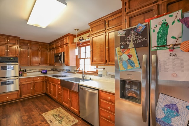 3715 Sinclair Dam Rd, Milledgeville, GA 31061 - kitchen with light countertops, a sink, appliances with stainless steel finishes, dark wood finished floors, and brown cabinets