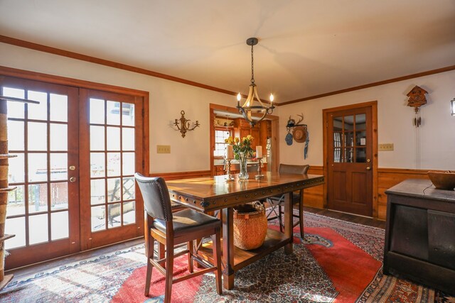 3715 Sinclair Dam Rd, Milledgeville, GA 31061 - dining space with a wainscoted wall, crown molding, french doors, and an inviting chandelier