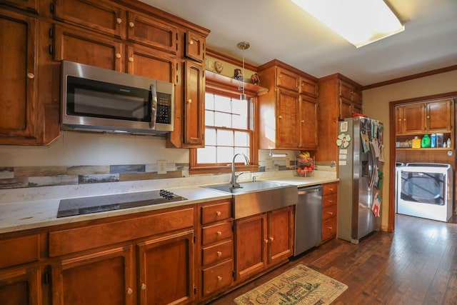 3715 Sinclair Dam Rd, Milledgeville, GA 31061 - kitchen featuring light countertops, crown molding, a sink, washer / dryer, and appliances with stainless steel finishes