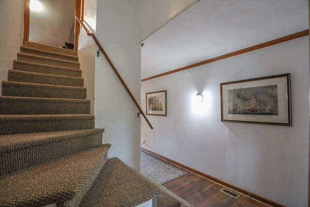 3715 Sinclair Dam Rd, Milledgeville, GA 31061 - staircase with wood finished floors, baseboards, and visible vents
