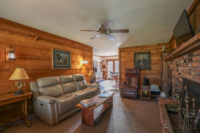 3715 Sinclair Dam Rd, Milledgeville, GA 31061 - living area featuring carpet flooring, wood walls, a fireplace, and ceiling fan