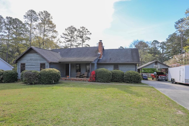 3715 Sinclair Dam Rd, Milledgeville, GA 31061 - single story home with a chimney, a front lawn, concrete driveway, and a carport