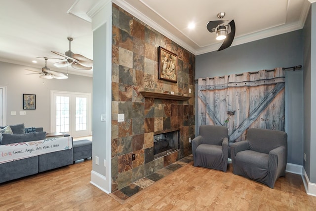 116 Island Dr, Milledgeville, GA 31061 - living area featuring ornamental molding, ceiling fan, wood finished floors, a tile fireplace, and baseboards