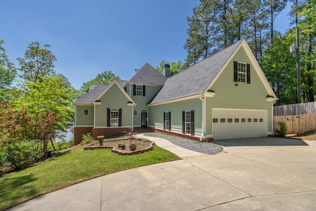 116 Island Dr, Milledgeville, GA 31061 - traditional-style home featuring driveway, a garage, roof with shingles, a chimney, and brick siding