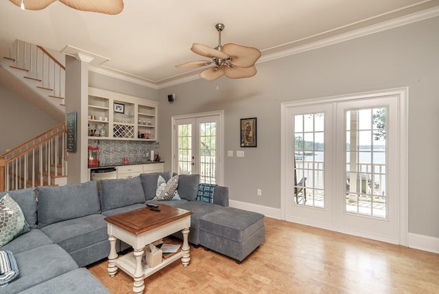 116 Island Dr, Milledgeville, GA 31061 - living area with a dry bar, french doors, stairway, ceiling fan, and ornamental molding