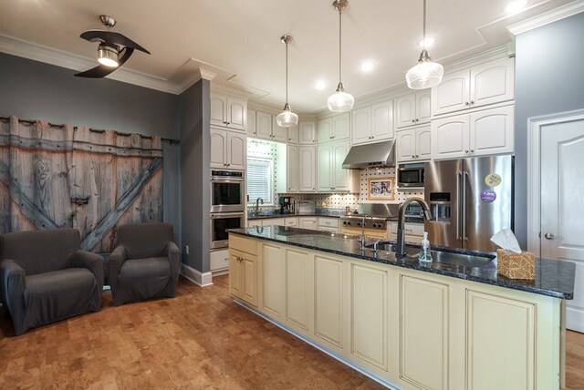 116 Island Dr, Milledgeville, GA 31061 - kitchen with appliances with stainless steel finishes, crown molding, a sink, dark stone countertops, and decorative backsplash