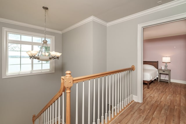 116 Island Dr, Milledgeville, GA 31061 - hallway featuring an upstairs landing, a chandelier, wood finished floors, ornamental molding, and baseboards