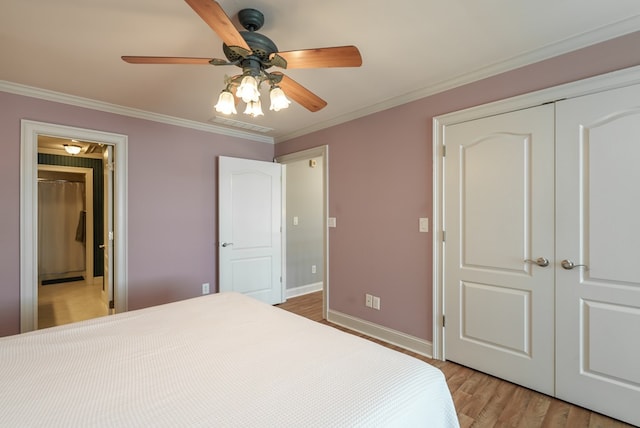 116 Island Dr, Milledgeville, GA 31061 - bedroom with light wood finished floors, a closet, ornamental molding, baseboards, and ceiling fan