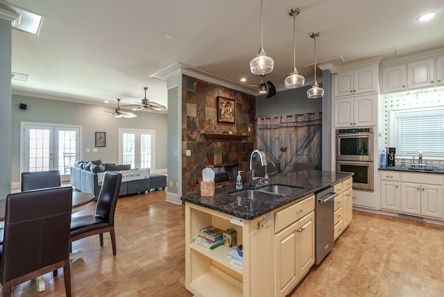 116 Island Dr, Milledgeville, GA 31061 - kitchen featuring a sink, crown molding, appliances with stainless steel finishes, open floor plan, and dark stone counters