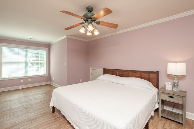 116 Island Dr, Milledgeville, GA 31061 - bedroom featuring baseboards, light wood-style floors, crown molding, and a ceiling fan