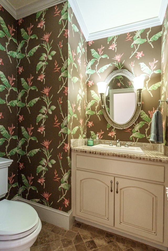 116 Island Dr, Milledgeville, GA 31061 - half bathroom with ornamental molding, wallpapered walls, toilet, baseboards, and vanity