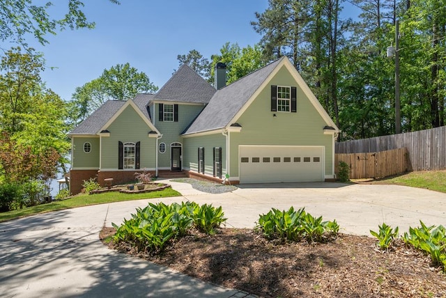 116 Island Dr, Milledgeville, GA 31061 - view of front of house with fence, driveway, a chimney, an attached garage, and brick siding