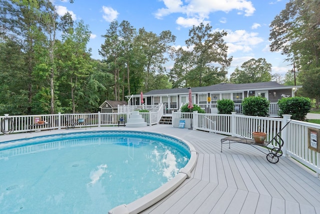 view of swimming pool with a wooden deck