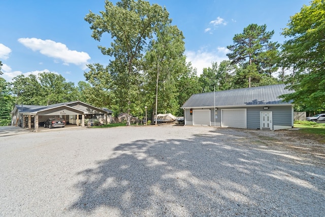 view of side of property with a carport and a garage