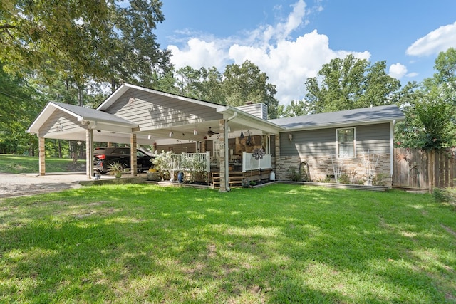 exterior space with a lawn and a carport