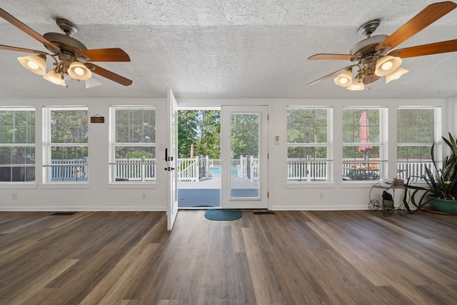 unfurnished sunroom featuring plenty of natural light and ceiling fan