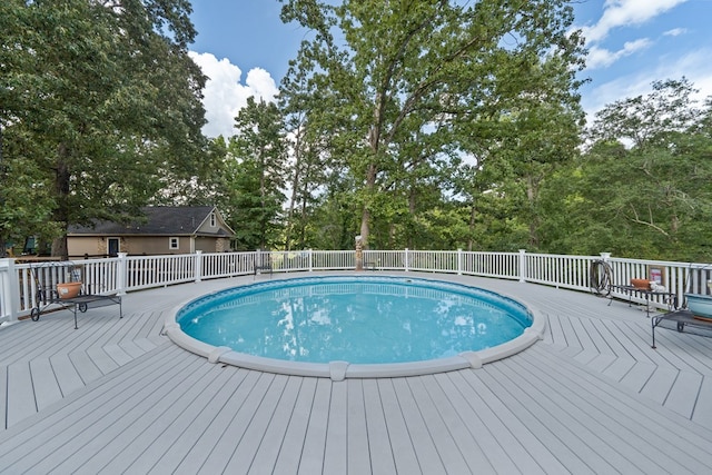 view of swimming pool with a wooden deck