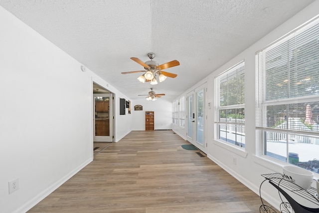 interior space with light hardwood / wood-style flooring and a textured ceiling