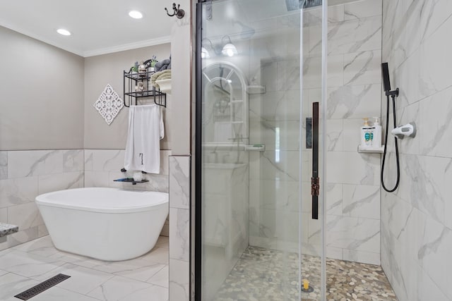 bathroom with shower with separate bathtub, tile walls, and ornamental molding