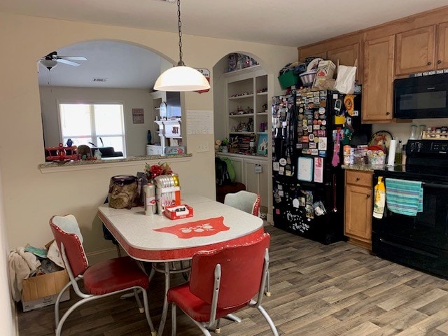 1683 Sara Hunter Ln, Milledgeville, GA 31061 - dining area with a ceiling fan, light wood-style floors, and arched walkways
