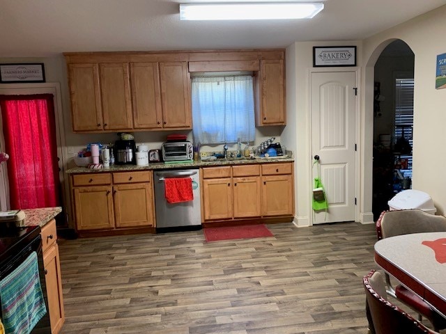 1683 Sara Hunter Ln, Milledgeville, GA 31061 - kitchen featuring dishwasher, arched walkways, light wood-type flooring, stone counters, and black range with electric cooktop