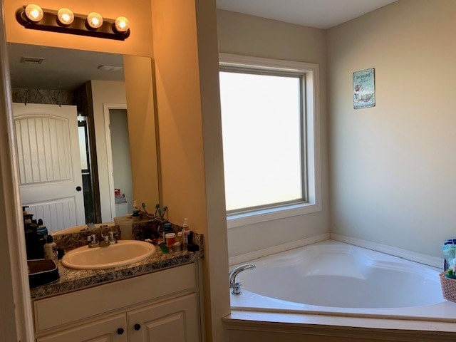 1683 Sara Hunter Ln, Milledgeville, GA 31061 - full bathroom with vanity and a garden tub