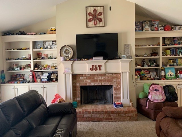 1683 Sara Hunter Ln, Milledgeville, GA 31061 - carpeted living area with vaulted ceiling and a fireplace
