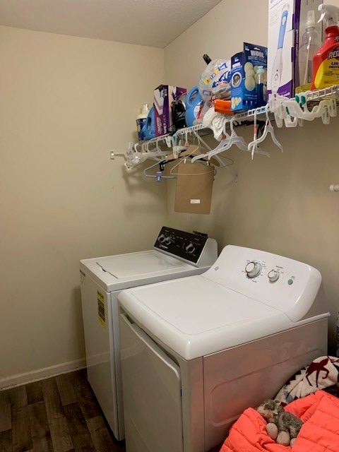 1683 Sara Hunter Ln, Milledgeville, GA 31061 - washroom with washing machine and dryer and wood finished floors