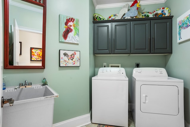 laundry area with cabinets, ornamental molding, separate washer and dryer, and sink