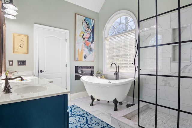 bathroom with vanity, a bathing tub, and vaulted ceiling