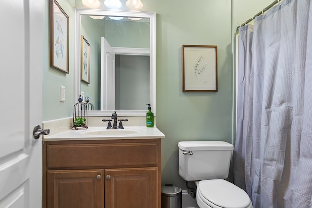 bathroom featuring vanity, toilet, and a shower with shower curtain