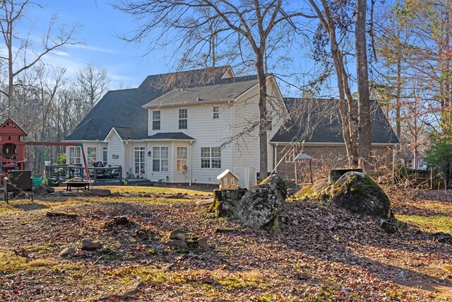 rear view of property with a lawn and a wooden deck