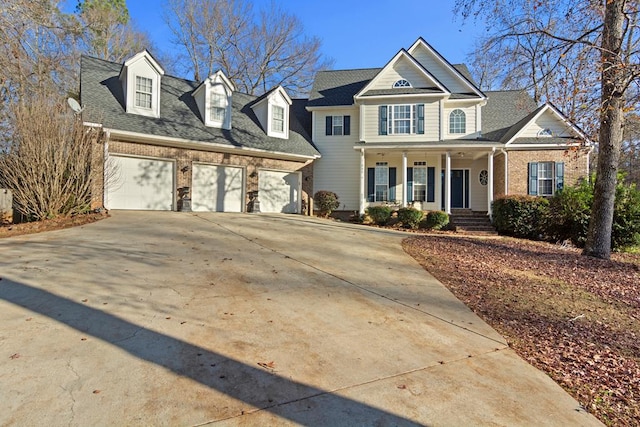 view of front of property featuring covered porch and a garage