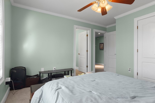 carpeted bedroom with crown molding and ceiling fan