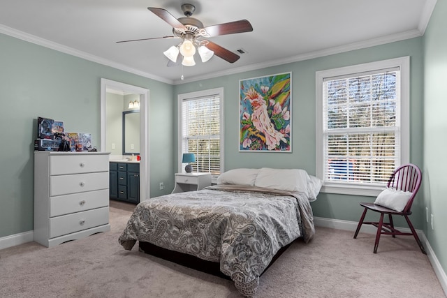 carpeted bedroom with multiple windows, ornamental molding, and ensuite bath