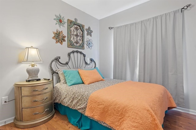 bedroom with hardwood / wood-style floors