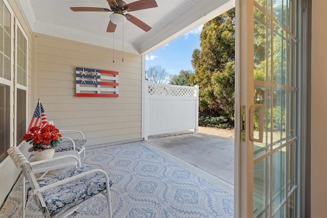 sunroom / solarium featuring ceiling fan and a healthy amount of sunlight