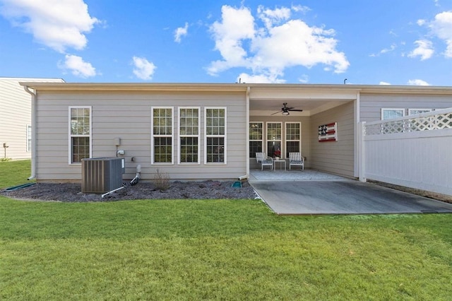 rear view of property with central AC unit, a patio area, ceiling fan, and a lawn