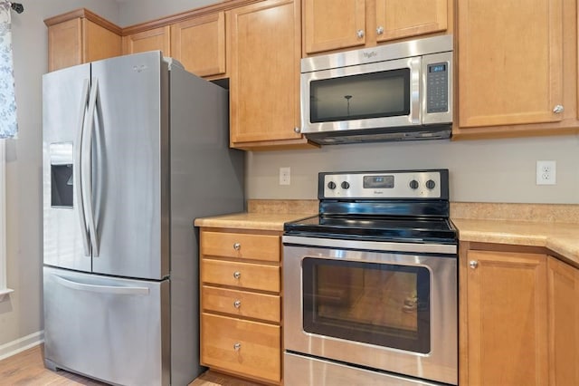 kitchen featuring light hardwood / wood-style flooring and stainless steel appliances