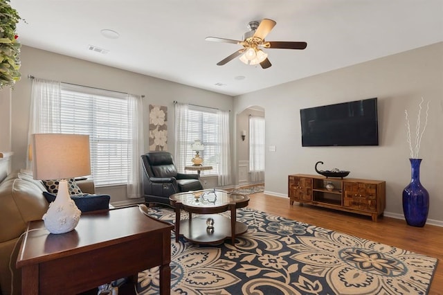 living room with plenty of natural light, hardwood / wood-style floors, and ceiling fan