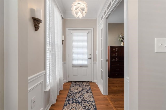 entryway with crown molding and hardwood / wood-style floors