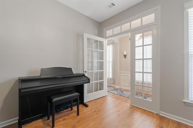 misc room featuring french doors and light wood-type flooring