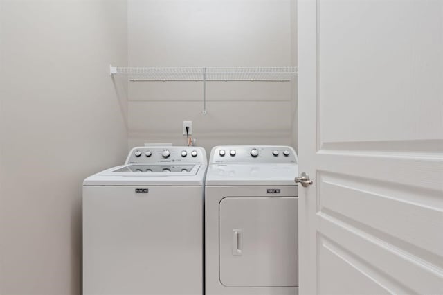 washroom with separate washer and dryer