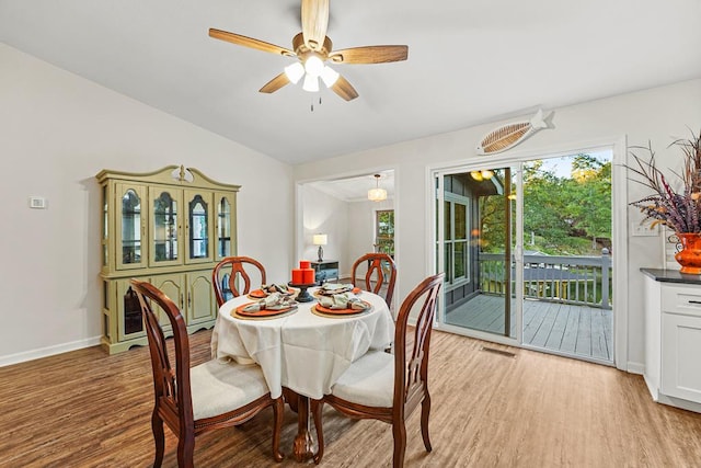 dining area featuring a ceiling fan, baseboards, visible vents, and light wood finished floors