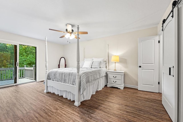 bedroom with ceiling fan, a barn door, access to exterior, and dark wood-type flooring