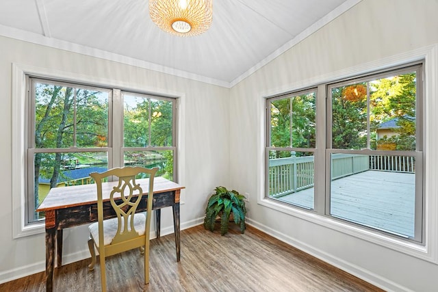 dining room with ornamental molding, wood finished floors, and baseboards