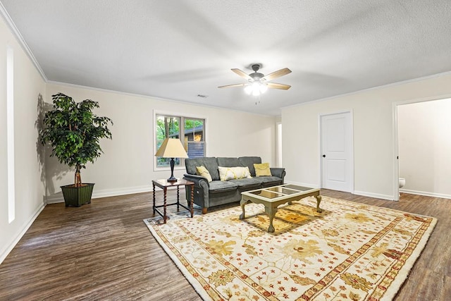 living room featuring baseboards, dark wood-type flooring, and ornamental molding