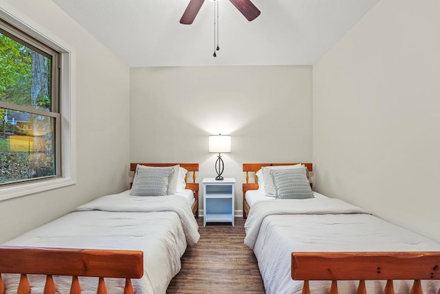 bedroom with ceiling fan and dark wood-type flooring